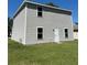 The two-story building boasts vinyl siding and a well-maintained lawn at 49 Inconnu Dr, Poinciana, FL 34759