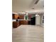 Kitchen featuring wood cabinets, black appliances and gray backsplash at 49 Inconnu Dr, Poinciana, FL 34759