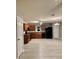 Kitchen featuring wood cabinets, black appliances and gray backsplash at 49 Inconnu Dr, Poinciana, FL 34759