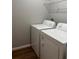 The laundry room includes a full-size white washer and dryer set at 49 Inconnu Dr, Poinciana, FL 34759