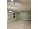 Open-concept living room with gray walls, modern ceiling fan and light wood floors at 49 Inconnu Dr, Poinciana, FL 34759