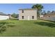 Generous backyard with ample green space leading to the rear of the two-story home at 49 Inconnu Dr, Poinciana, FL 34759