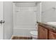 Bright bathroom features a tub/shower combo, dark wood vanity, and light gray walls at 49 Inconnu Dr, Poinciana, FL 34759