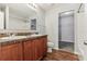 Bright bathroom features double sinks, dark wood vanity, and light gray walls at 49 Inconnu Dr, Poinciana, FL 34759