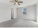 This bedroom has light grey walls and plush carpeting and a ceiling fan at 49 Inconnu Dr, Poinciana, FL 34759
