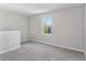 Bright carpeted bedroom featuring a large window with neighborhood views at 49 Inconnu Dr, Poinciana, FL 34759