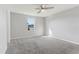 This bedroom has light grey walls and plush carpeting and a ceiling fan at 49 Inconnu Dr, Poinciana, FL 34759