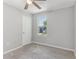 Bright bedroom with neutral carpet, showing a door and window allowing natural light to fill the space at 49 Inconnu Dr, Poinciana, FL 34759