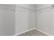 Walk-in closet with a carpeted floor, white wire shelving, and light gray walls at 49 Inconnu Dr, Poinciana, FL 34759