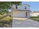 Charming two-story home with a spacious driveway and attached two-car garage at 49 Inconnu Dr, Poinciana, FL 34759