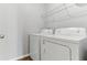 White laundry room features a washing machine and dryer, offering convenience at 49 Inconnu Dr, Poinciana, FL 34759
