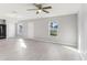 Living room featuring laminated floors, neutral walls, ceiling fan, and lots of natural light at 49 Inconnu Dr, Poinciana, FL 34759