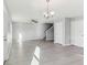 Bright living room featuring gray walls, modern light fixtures, and durable laminate flooring at 49 Inconnu Dr, Poinciana, FL 34759