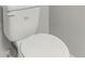 Close-up of a white toilet, showcasing its clean and modern design at 49 Inconnu Dr, Poinciana, FL 34759