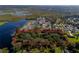 Aerial view of a lot surrounded by a red line, full of trees and greenery with lake in view at 495 Orange Ave, St Cloud, FL 34769