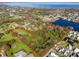 Aerial view of the property highlighting the surrounding area, water features, and bordering the shoreline at 495 Orange Ave, St Cloud, FL 34769