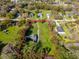 Aerial view of a lot surrounded by a red line, with trees and greenery at 495 Orange Ave, St Cloud, FL 34769