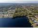 Scenic aerial view of lakefront homes with docks surrounded by lush trees and serene waters at 495 Orange Ave, St Cloud, FL 34769