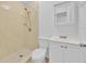 Tiled bathroom with a shower stall, toilet, and a white vanity with storage at 495 Orange Ave, St Cloud, FL 34769