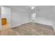 Spacious bedroom with laminate flooring, a closet, and natural light through the windows at 495 Orange Ave, St Cloud, FL 34769