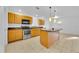 Well-lit kitchen featuring wooden cabinets, a stainless steel oven, and a kitchen island at 495 Orange Ave, St Cloud, FL 34769