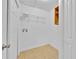 Functional laundry room with tile floor, shelving, and ample space for appliances at 495 Orange Ave, St Cloud, FL 34769