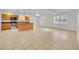 Spacious open-concept living area with tile flooring and open access to the kitchen at 495 Orange Ave, St Cloud, FL 34769
