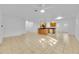 Spacious open-concept living area with tile flooring, connecting kitchen and dining at 495 Orange Ave, St Cloud, FL 34769