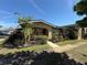 Quaint home with well-kept garden beds, framed by a concrete path and lush greenery at 502 Polaris Loop # 110, Casselberry, FL 32707