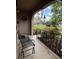 Inviting front porch featuring an arched entry, black metal bench, garden view, and a wind chime at 502 Polaris Loop # 110, Casselberry, FL 32707