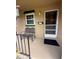 Inviting front porch featuring a metal bench, window, mailbox, and door into home at 502 Polaris Loop # 110, Casselberry, FL 32707