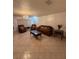 Spacious living room with tile floors, chandelier, and comfortable seating, ideal for relaxation and entertainment at 502 Polaris Loop # 110, Casselberry, FL 32707