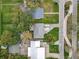 Aerial view of a neighborhood featuring well-maintained lawns, mature trees, and paved roads at 521 Florida Ave, St Cloud, FL 34769