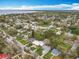 Wide aerial view of a coastal neighborhood with houses, trees, and a scenic body of water in the background at 521 Florida Ave, St Cloud, FL 34769