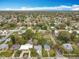 Expansive aerial view showing neighborhood streets and plentiful mature tree coverage at 521 Florida Ave, St Cloud, FL 34769