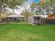 Well-maintained backyard with a shed, patio, and green lawn, perfect for outdoor activities and relaxation at 521 Florida Ave, St Cloud, FL 34769