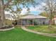 Exterior of the property shows a spacious backyard with covered patio seating at 521 Florida Ave, St Cloud, FL 34769