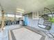 Cozy covered patio featuring a hanging chair, outdoor grill, and ample space for relaxation at 521 Florida Ave, St Cloud, FL 34769