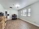 Bright dining area with hardwood floors, three windows, and ample natural light at 521 Florida Ave, St Cloud, FL 34769