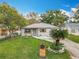 Charming single-story home featuring a manicured lawn, stone facade, and inviting front entrance at 521 Florida Ave, St Cloud, FL 34769
