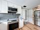 Modern kitchen showcasing stainless steel appliances, white cabinetry, and convenient pantry access at 521 Florida Ave, St Cloud, FL 34769