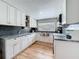 Bright kitchen featuring white cabinets, stainless steel appliances, and a large window at 521 Florida Ave, St Cloud, FL 34769