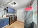 Functional laundry room with blue cabinets, laundry machines, and ample storage space at 521 Florida Ave, St Cloud, FL 34769