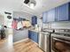 Well-organized laundry room with blue cabinets, modern washer/dryer, and wooden floors at 521 Florida Ave, St Cloud, FL 34769