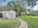 Backyard features a tidy storage shed and a spacious grassy area at 521 Florida Ave, St Cloud, FL 34769
