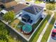 Aerial view of a fenced yard with an above ground pool, screened patio, and solar panels on the roof at 5640 Silver Thistle Ln, St Cloud, FL 34772