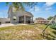 Spacious backyard with patio, screened-in porch, and play area perfect for outdoor living at 5640 Silver Thistle Ln, St Cloud, FL 34772