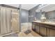 The bathroom features a shower, soaking tub, and a double sink vanity with dark wood cabinets at 5640 Silver Thistle Ln, St Cloud, FL 34772