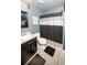 Cozy bathroom features a single vanity, toilet, and shower with modern fixtures and lighting at 5640 Silver Thistle Ln, St Cloud, FL 34772
