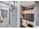 Bathroom featuring gray walls, a shower with neutral striped shower curtain and modern decor at 5640 Silver Thistle Ln, St Cloud, FL 34772